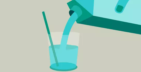 Hand pours the drink into a glass