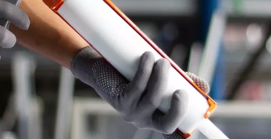 Man carrying a tube with adhesive to be applied to the surface