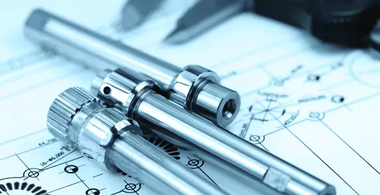 Image of the caliper with part on engineering drawing background